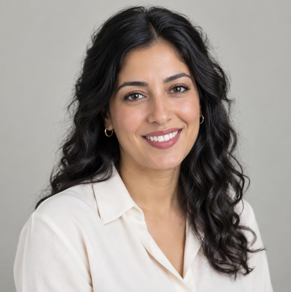 Portrait of a smiling woman with dark curly hair