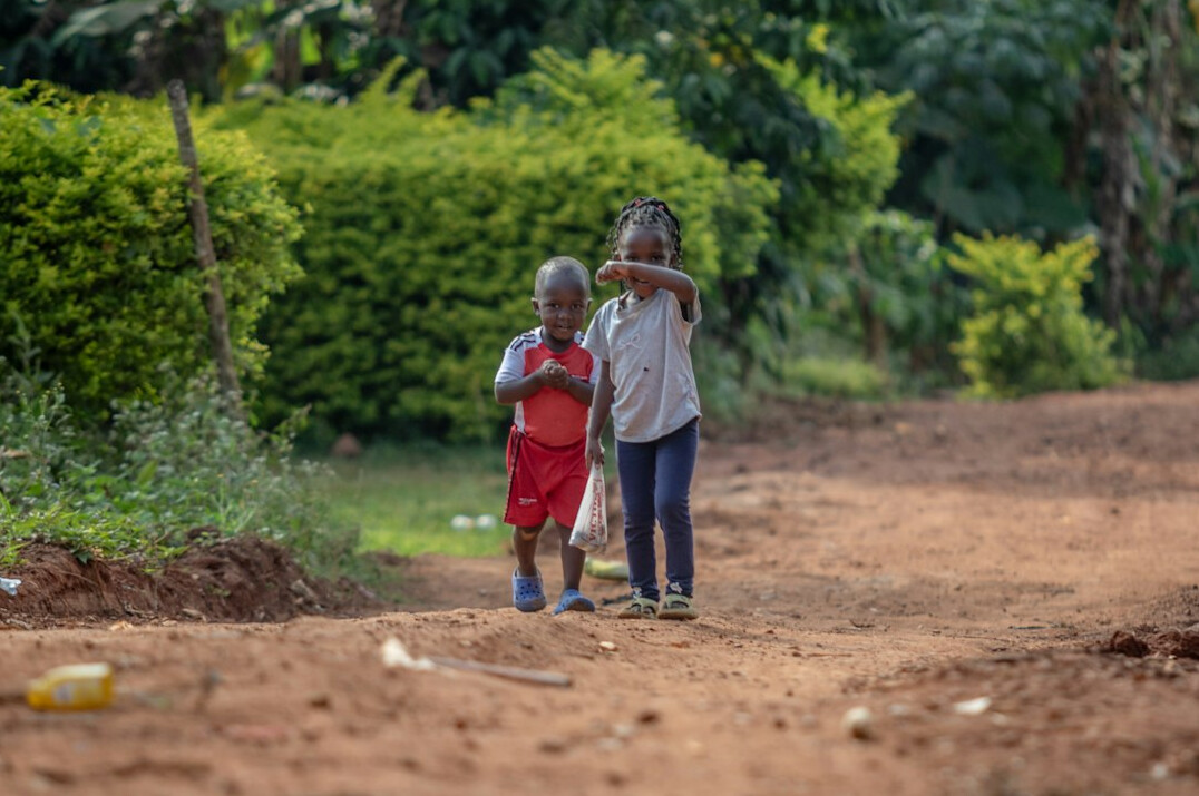 Children walking together near a road