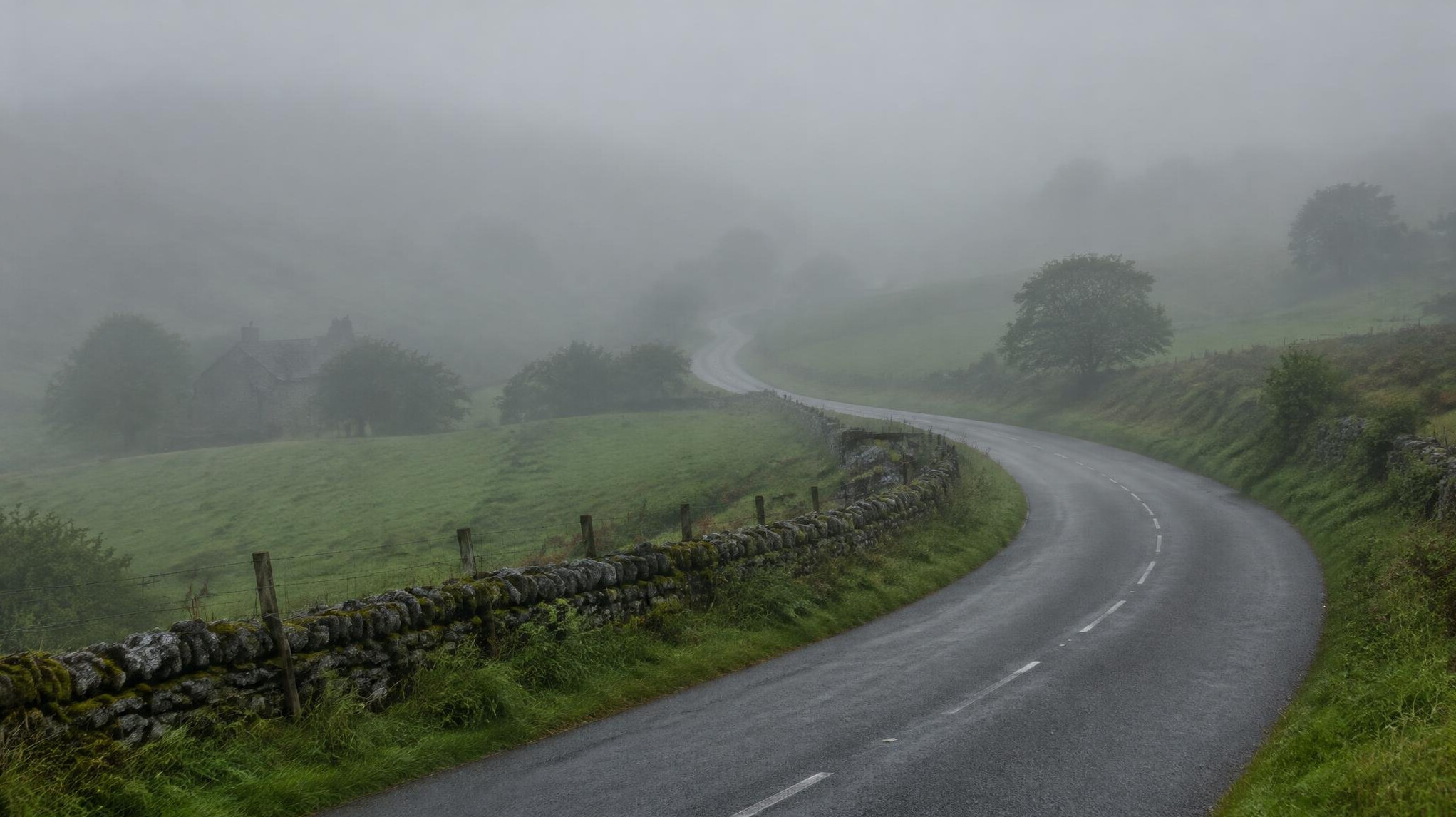 Winding road through misty landscape